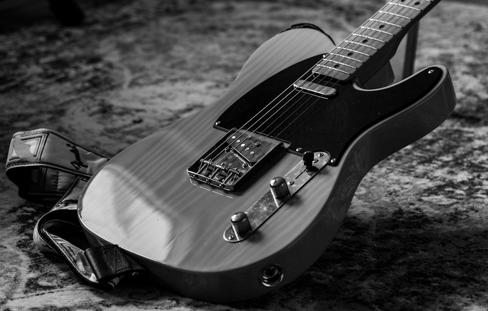 a black and white photo of an electric guitar