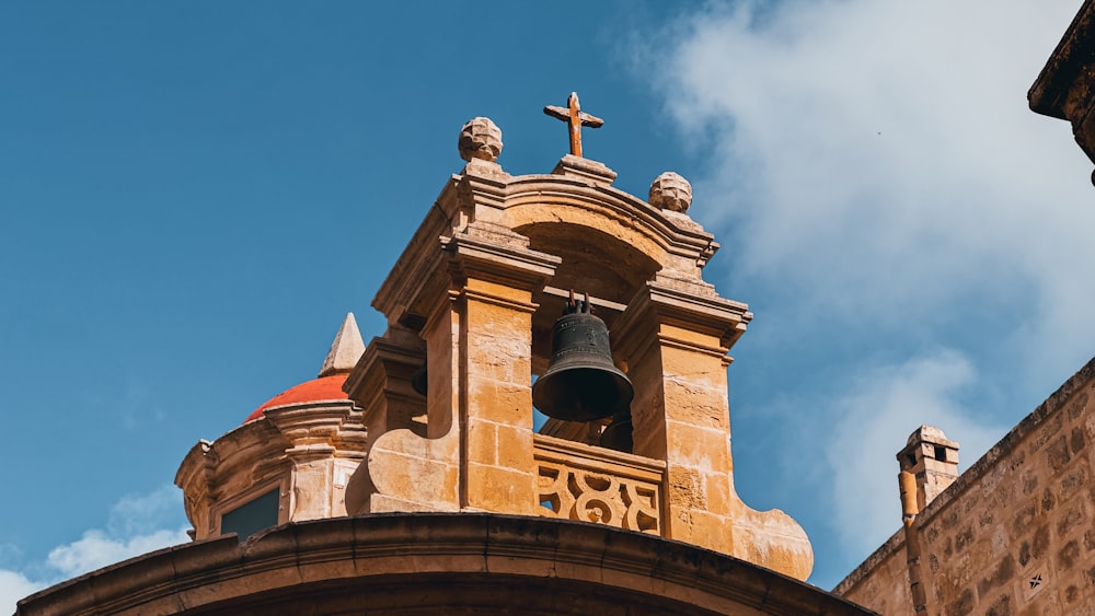 a bell tower with a cross on top of it