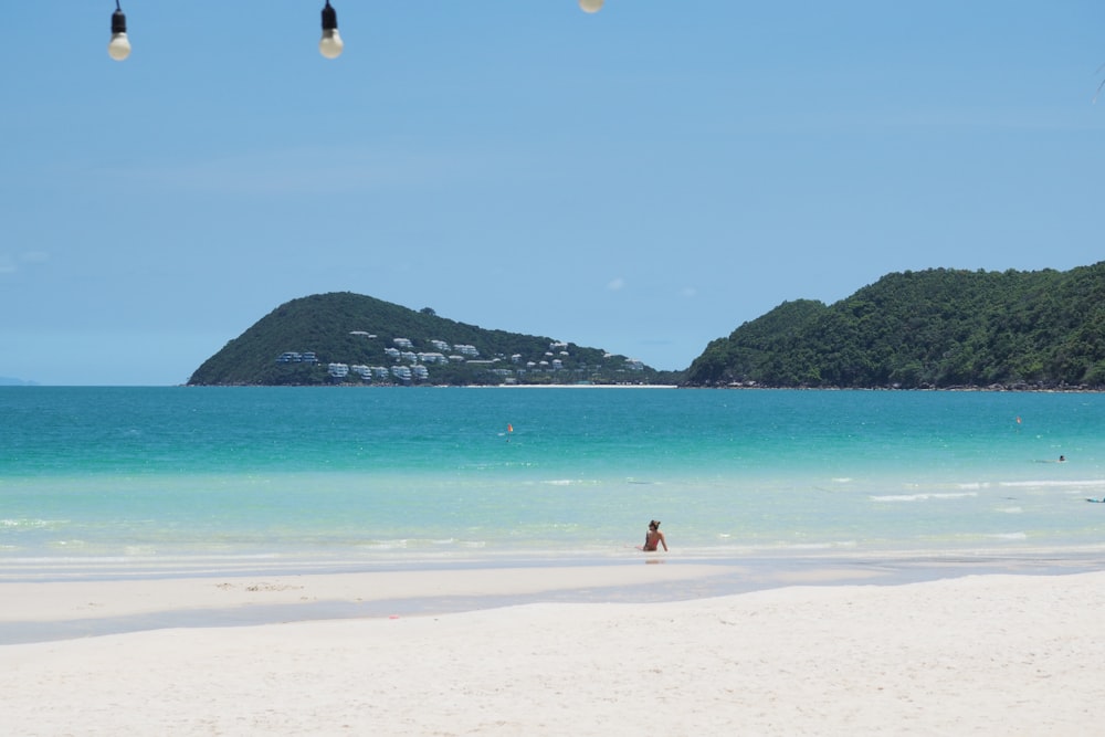 a person standing on a beach near the ocean