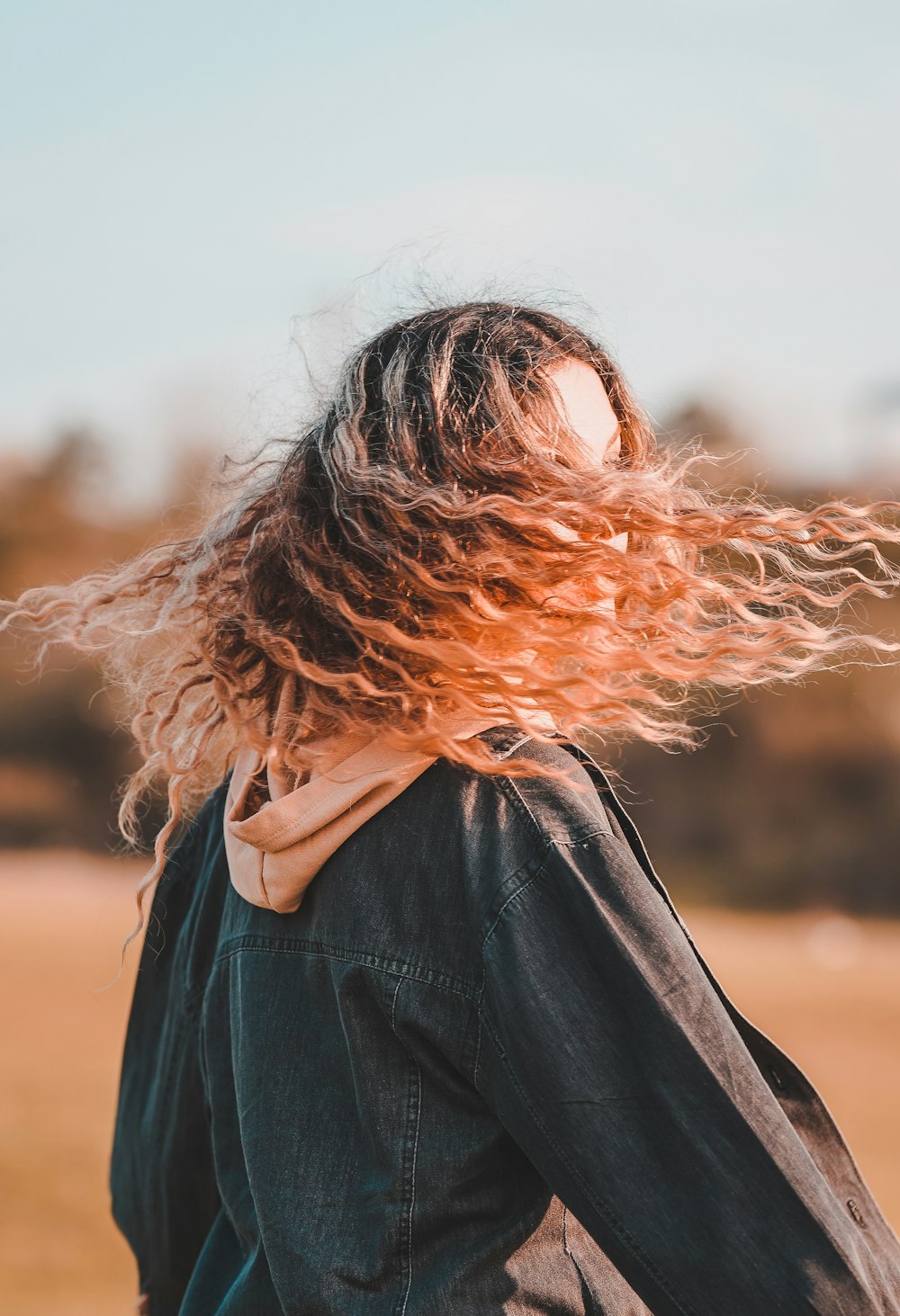 a woman with her hair blowing in the wind