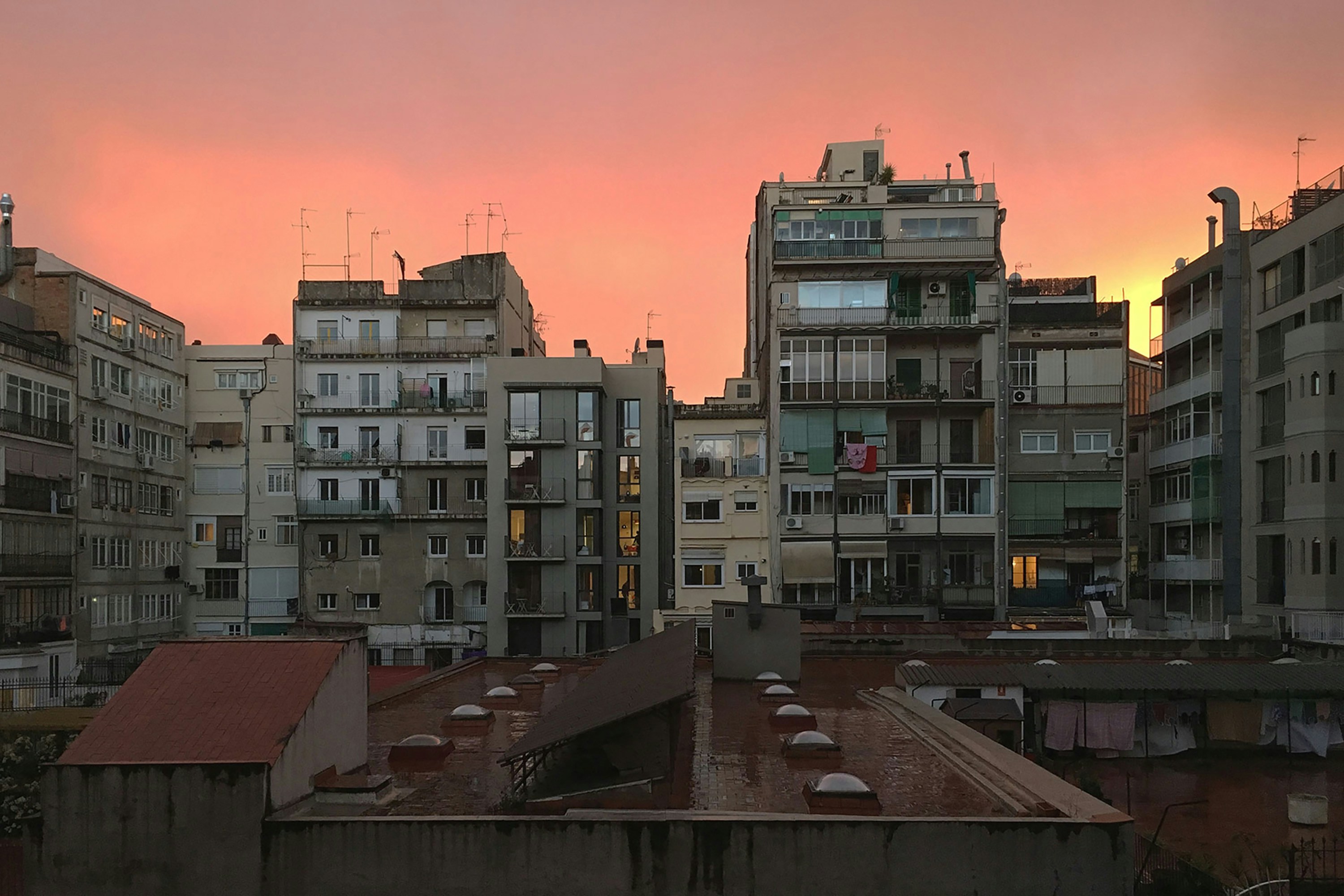 a view of a city at sunset from a rooftop