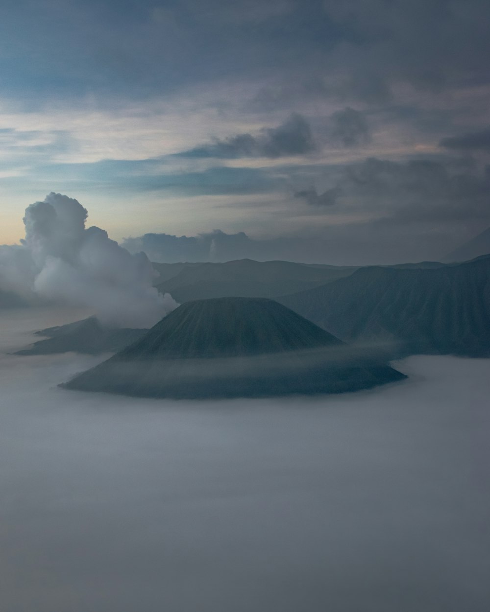 a view of a mountain covered in clouds