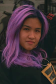 Before and after shot showcasing a vibrant hair coloring transformation with rich purple hues.