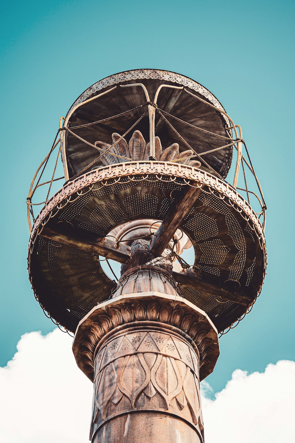 a tall tower with a fan on top of it