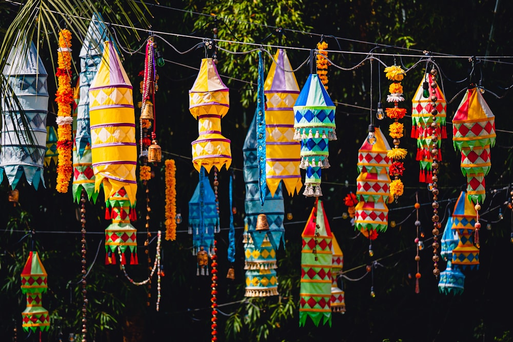 a bunch of colorful umbrellas hanging from a line