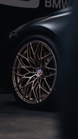 a close up of a car wheel on a dark background