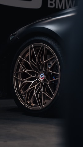 a close up of a car wheel on a dark background