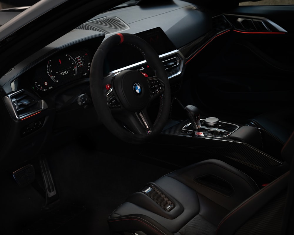 the interior of a car with a steering wheel and dashboard