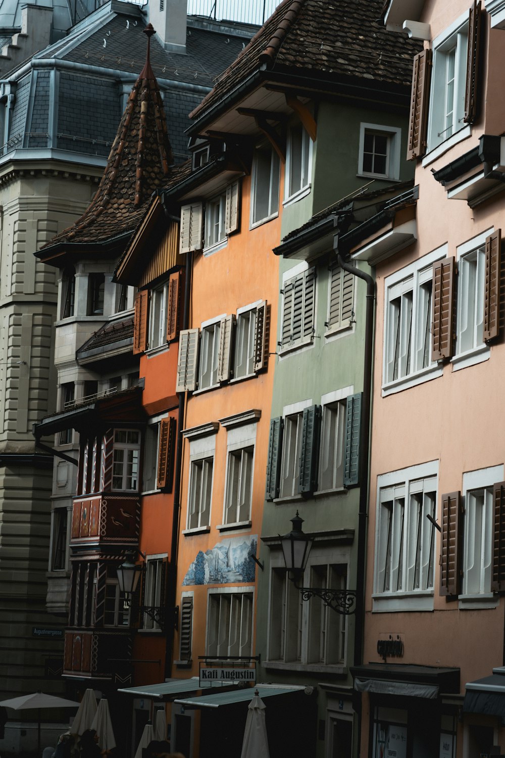 a row of multicolored buildings with open windows