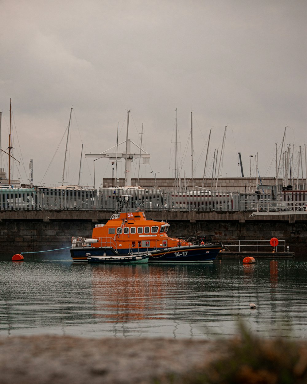a large orange boat floating on top of a body of water
