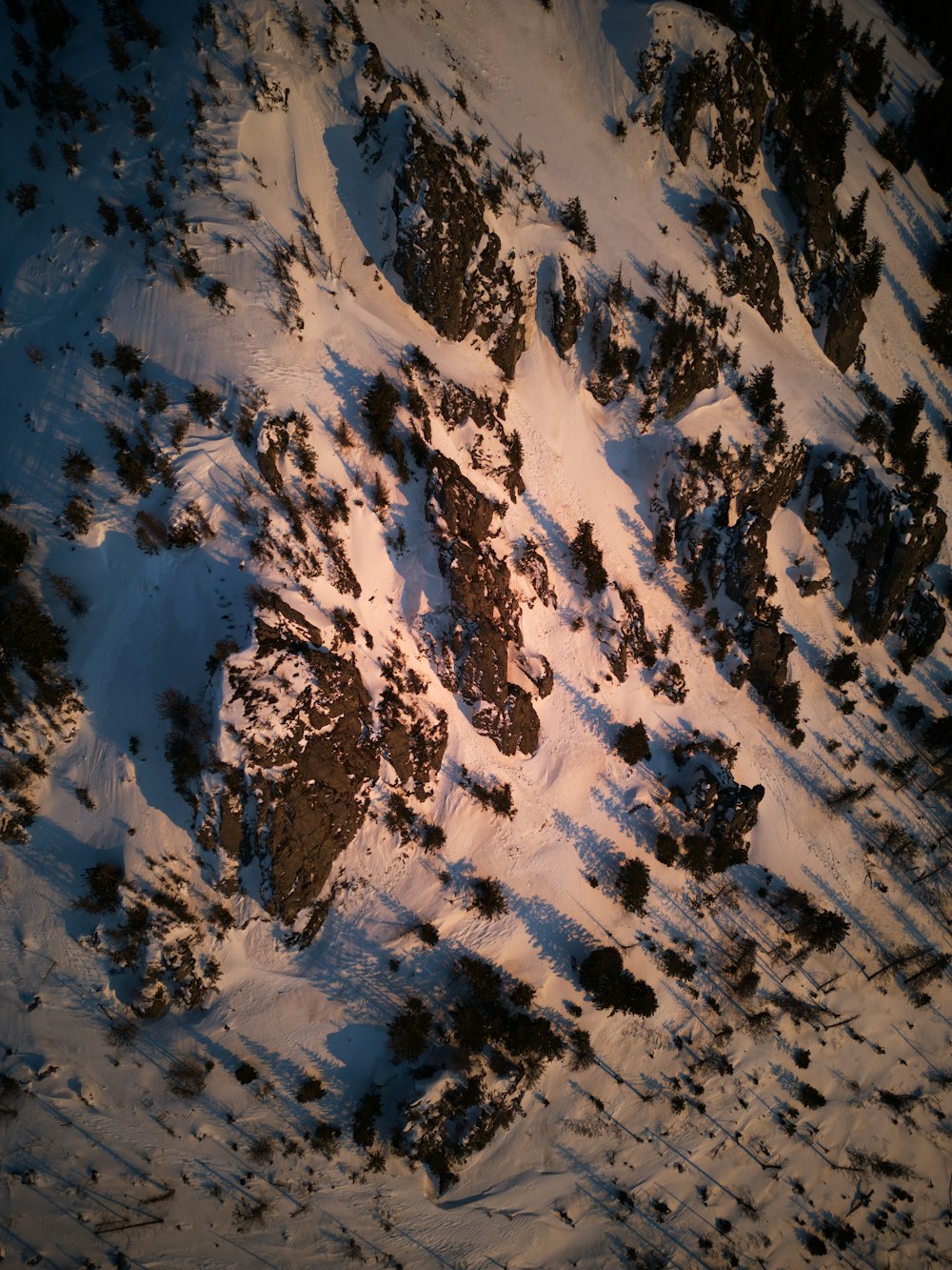 an aerial view of a snow covered mountain