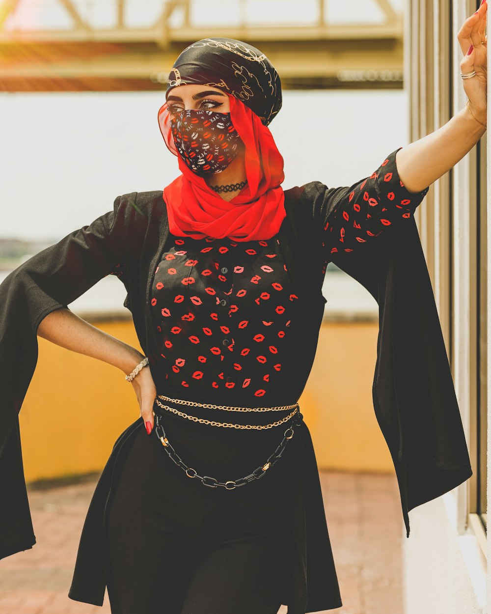 a woman in a black top and red scarf