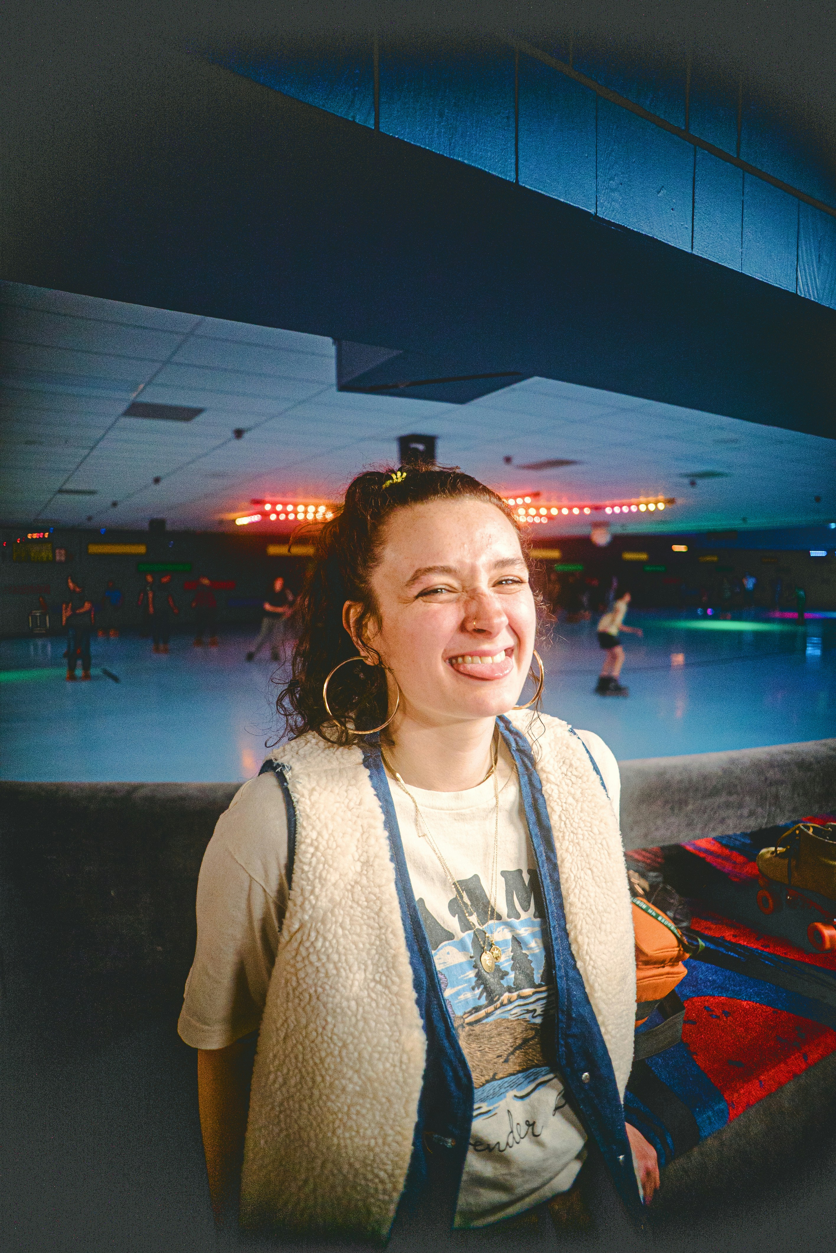 a woman standing in front of a skating rink