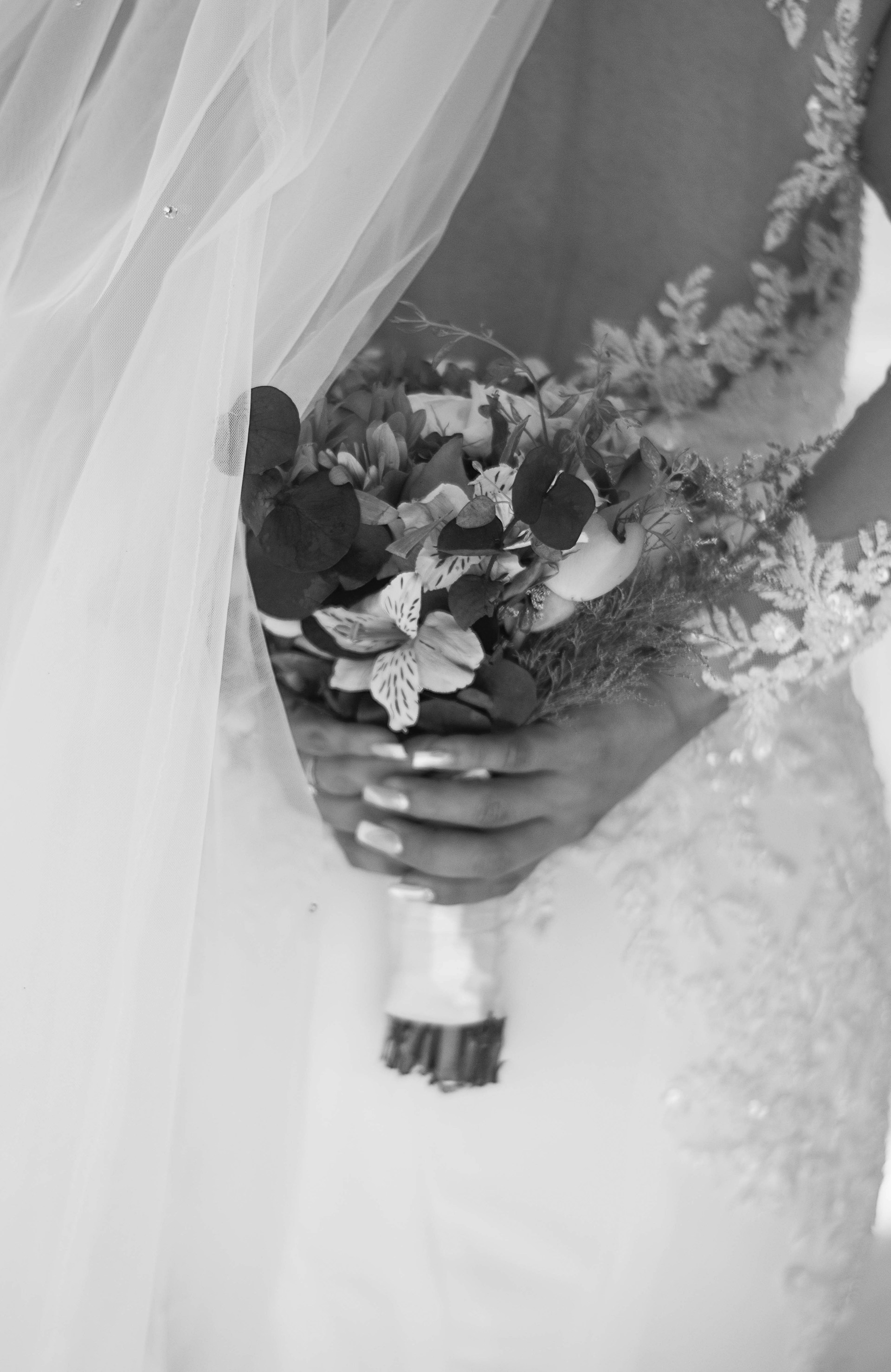 a woman in a wedding dress holding a bouquet of flowers