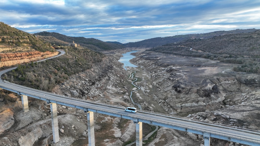 a car driving over a bridge over a river