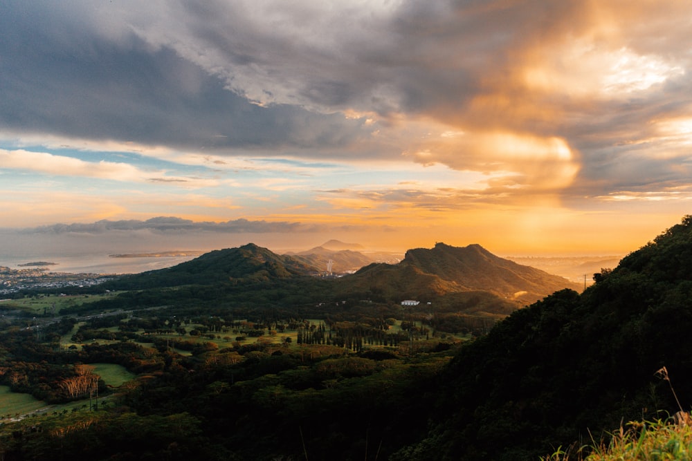 the sun is setting over a mountain range