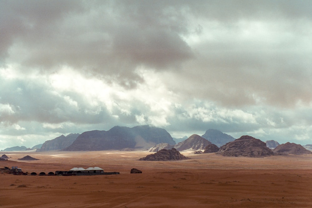 a desert landscape with mountains in the background