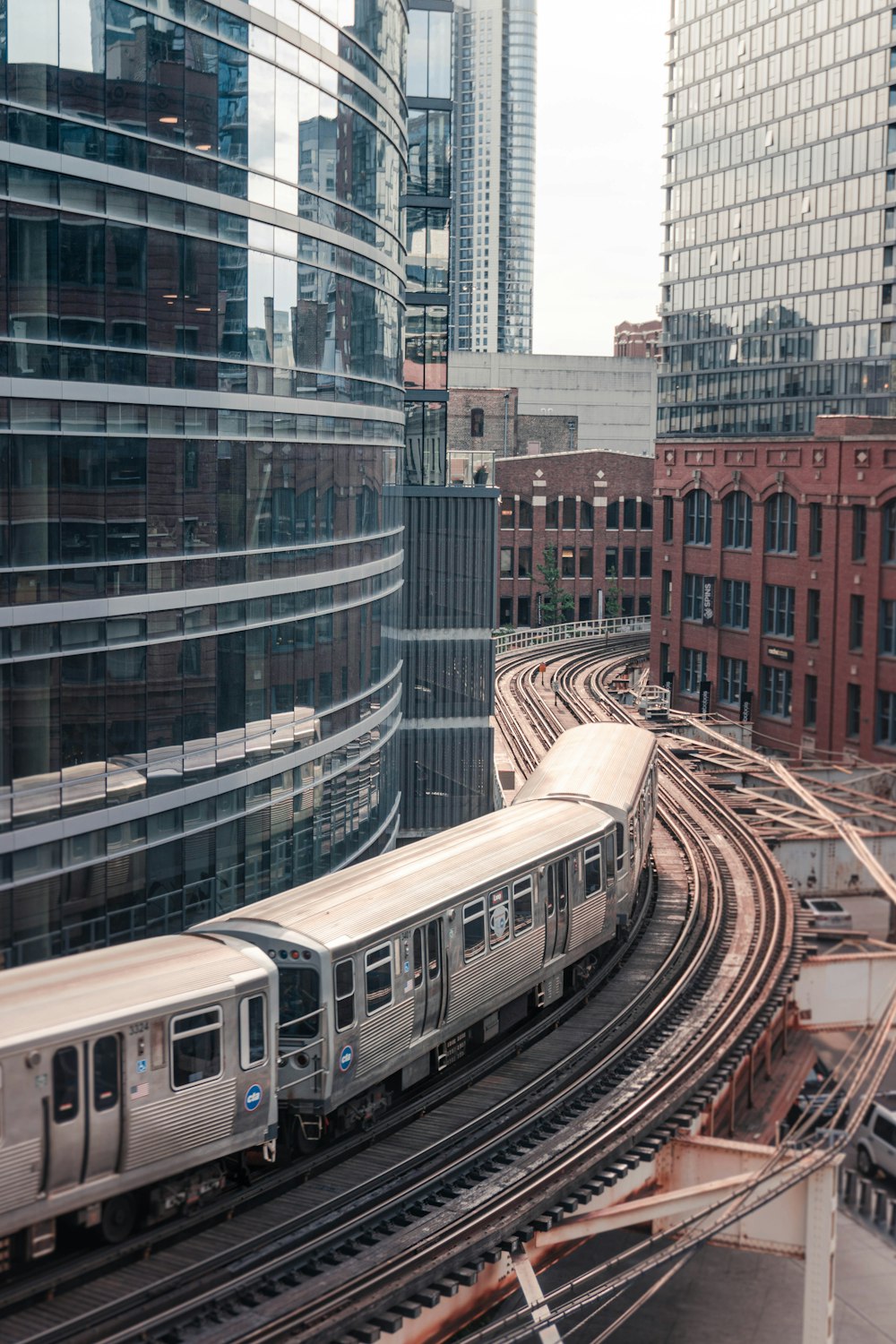 a train traveling through a city next to tall buildings