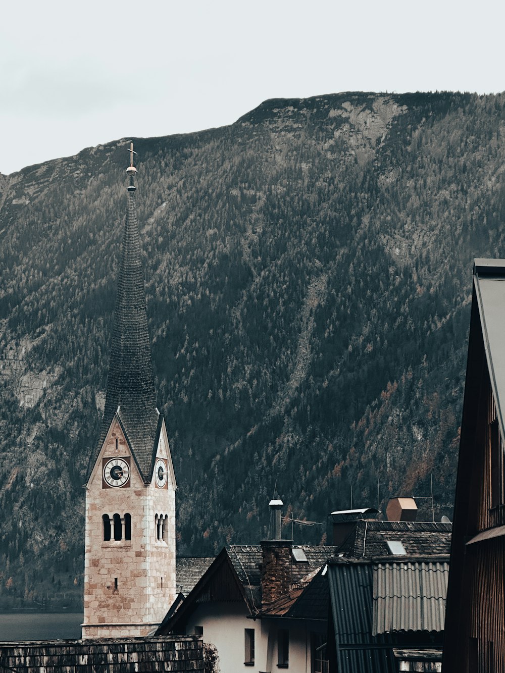 a clock tower on top of a building with a mountain in the background