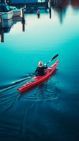 a man in a red kayak in the water