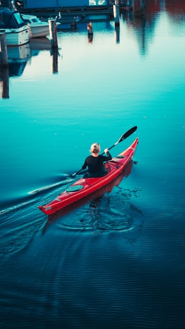 a man in a red kayak in the water
