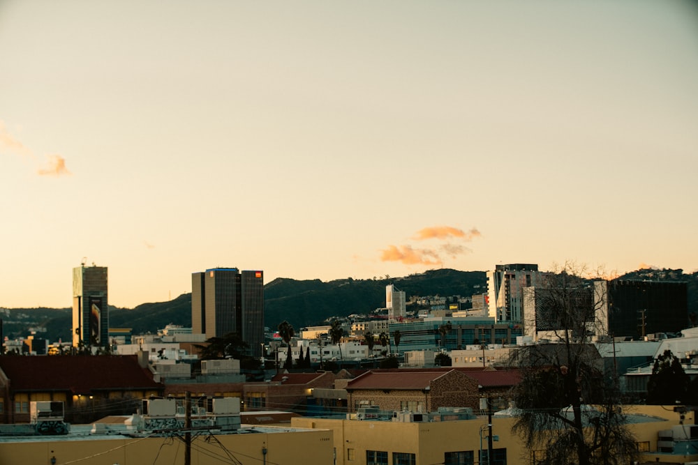 a view of a city with buildings and hills in the background