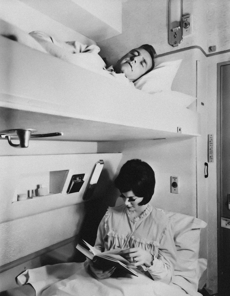 The cabin is smaller and cleverer than photos suggest - a made-up bed, reading light, washbasin, charging points, and a door that bolts from inside.