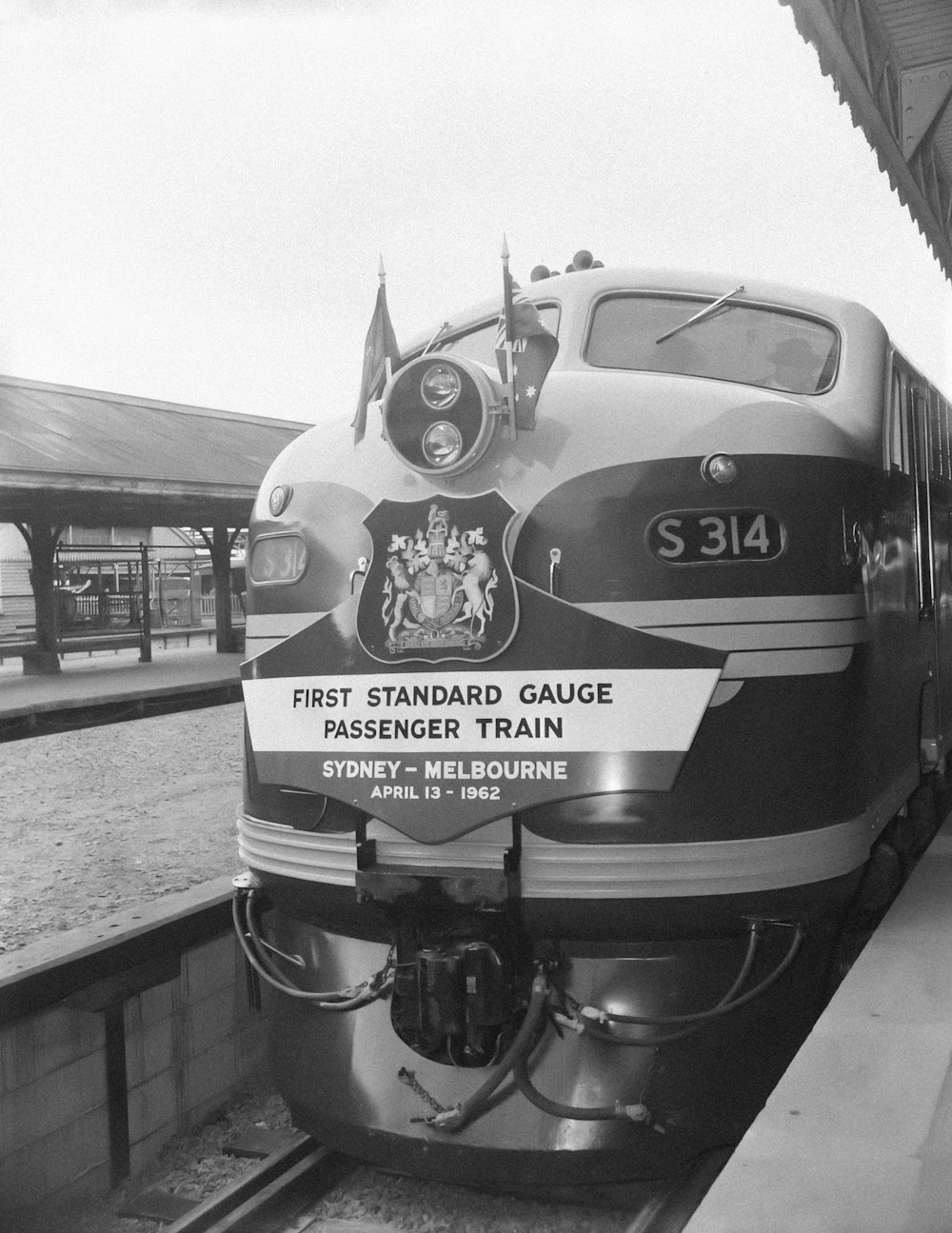 a black and white photo of a train at a station