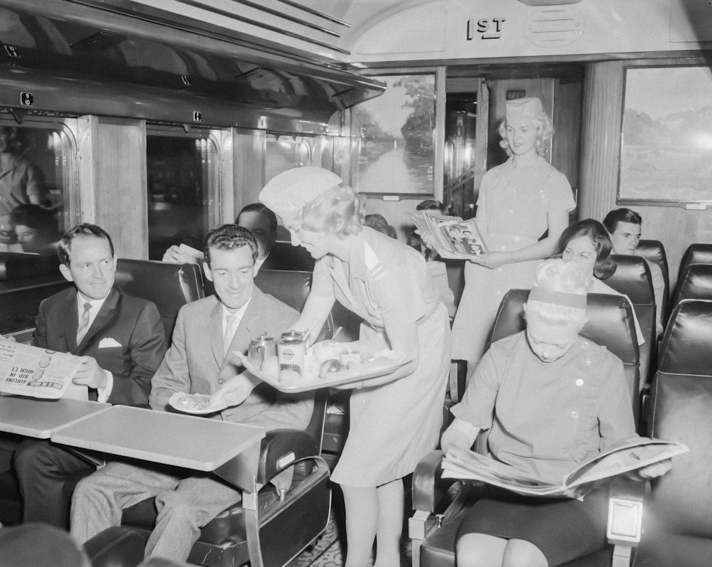 a black and white photo of people on a train