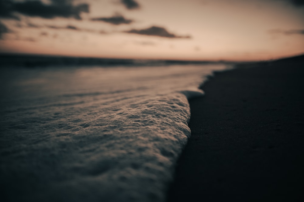 a close up of a wave on the beach