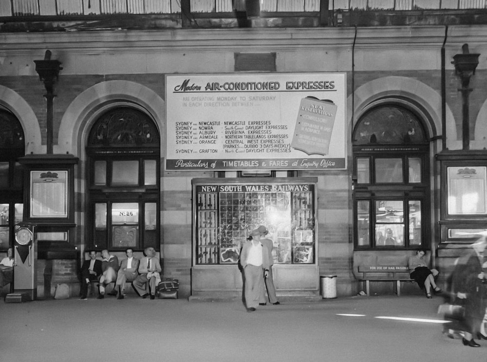 a group of people standing outside of a building