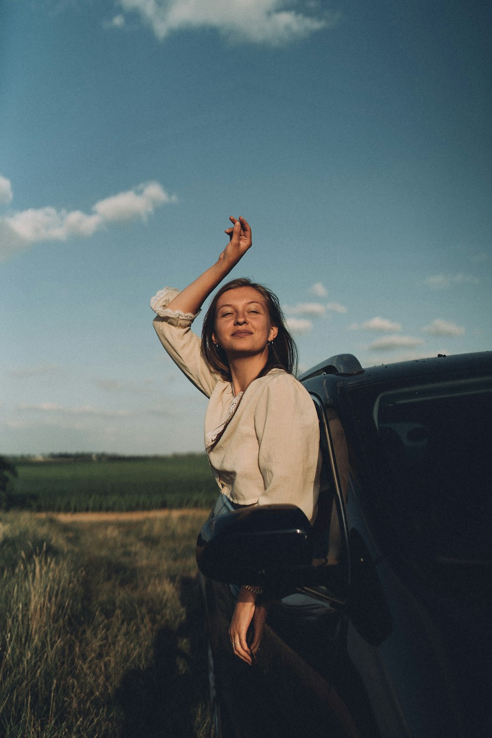 a woman leaning out the window of a car