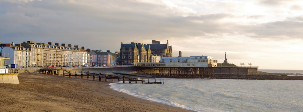 a sandy beach next to a row of buildings