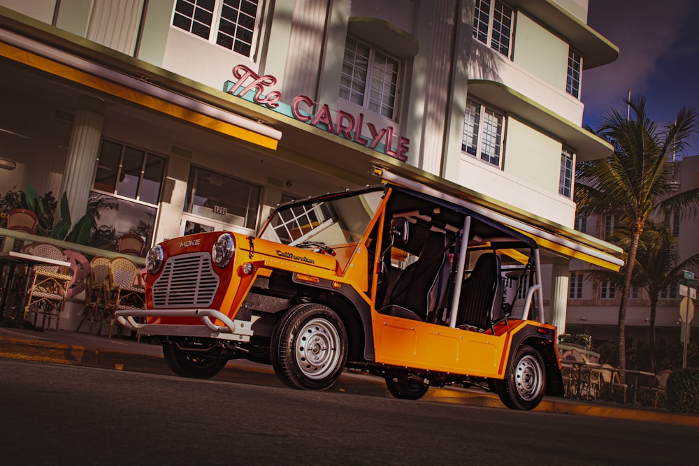 a yellow jeep parked in front of a building