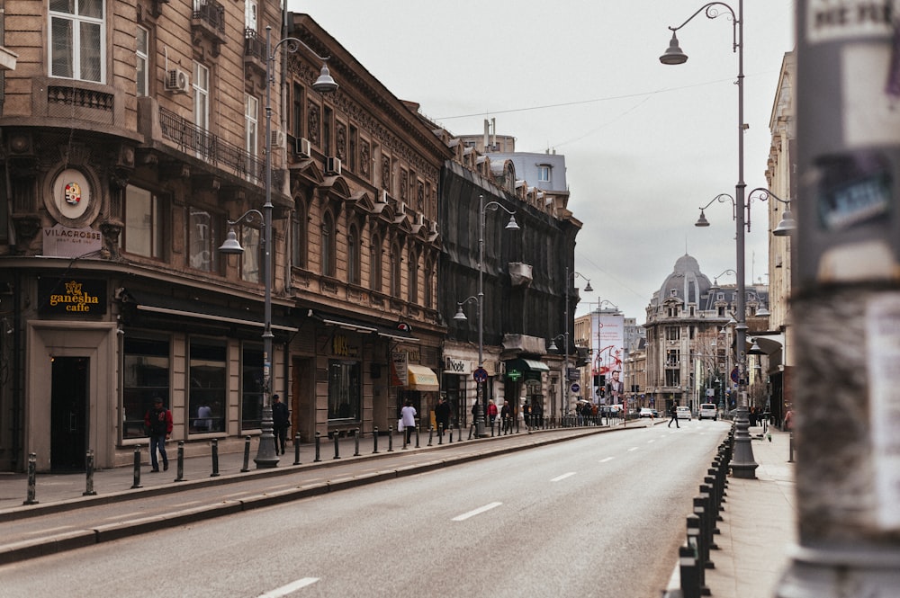 a city street with people walking on the sidewalks