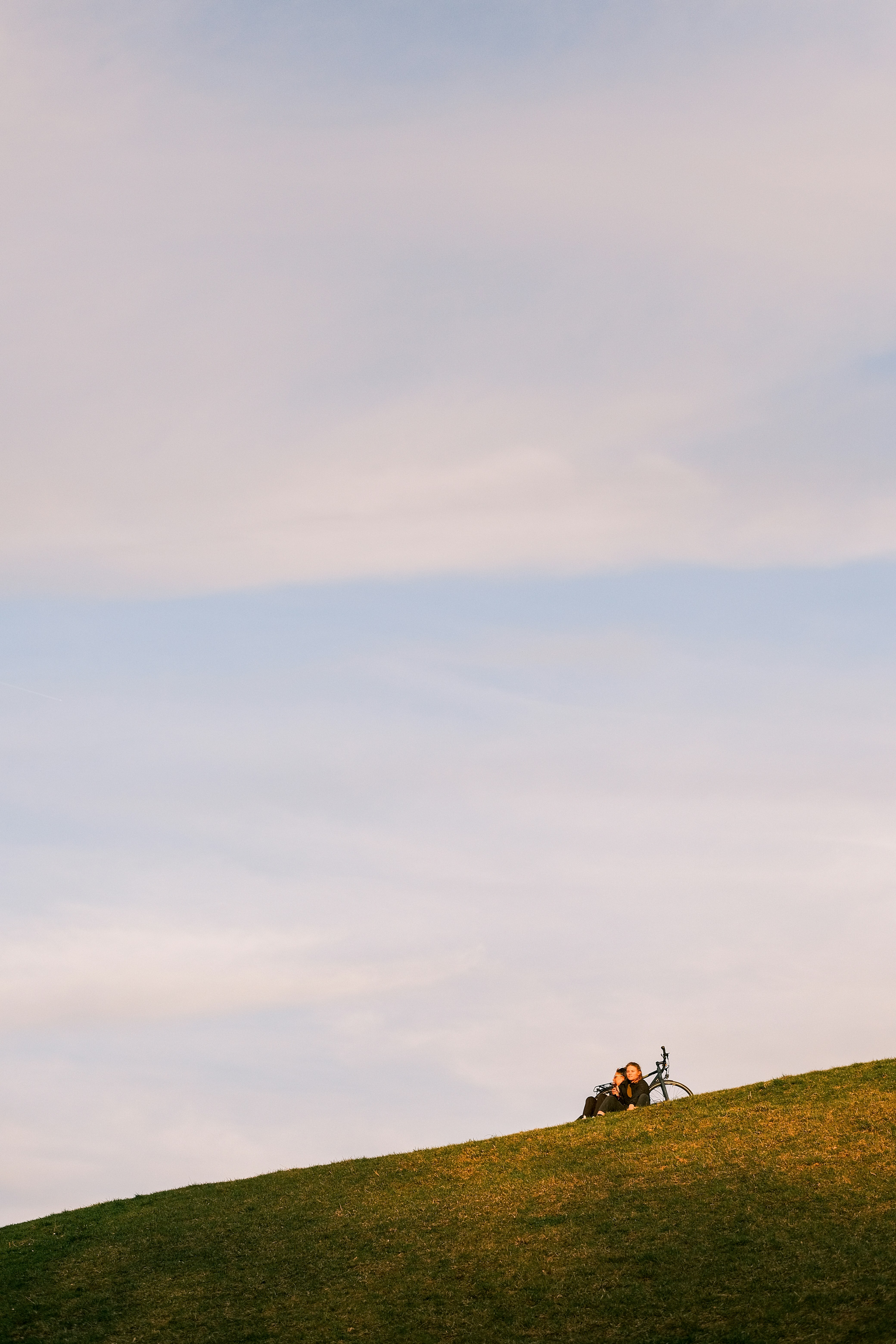 a person on a hill flying a kite