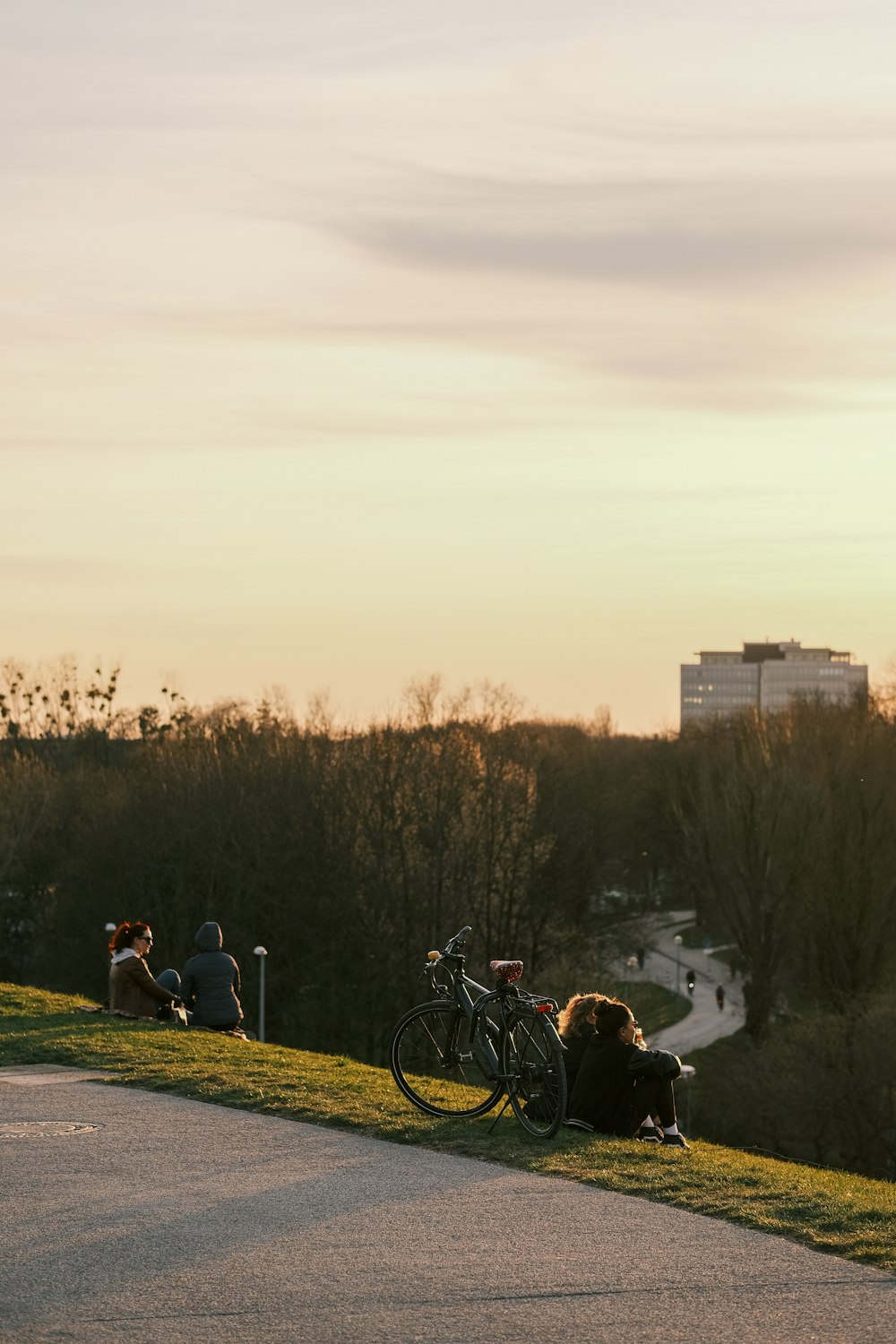 a couple of people sitting on top of a hill