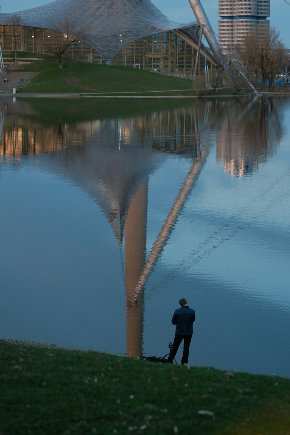 a man standing in front of a large body of water