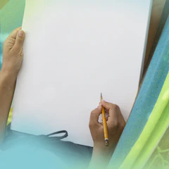 Image of a blank sketch pad with pencils and notes around, symbolizing the start of a creative process.