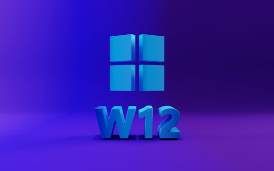 A 3D representation of a Windows logo comprised of four blue squares is centered against a purple gradient background. Below the logo, the characters 'W12' are displayed in the same blue hue, suggesting a version or concept related to Windows.