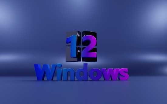 A 3D rendering features the number '12' above the word 'Windows'. The number is designed split with halves in blue and purple while the word 'Windows' is colored blue and transitions to purple on the right.