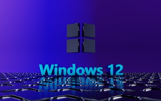 A 3D-rendered geometric surface in a digital environment features a prominently displayed text 'Windows 12' in bright blue, set against a stylish dark blue and purple background. Above the text, a three-dimensional cube icon reminiscent of a modern tech logo hovers, giving a futuristic and sleek appearance.