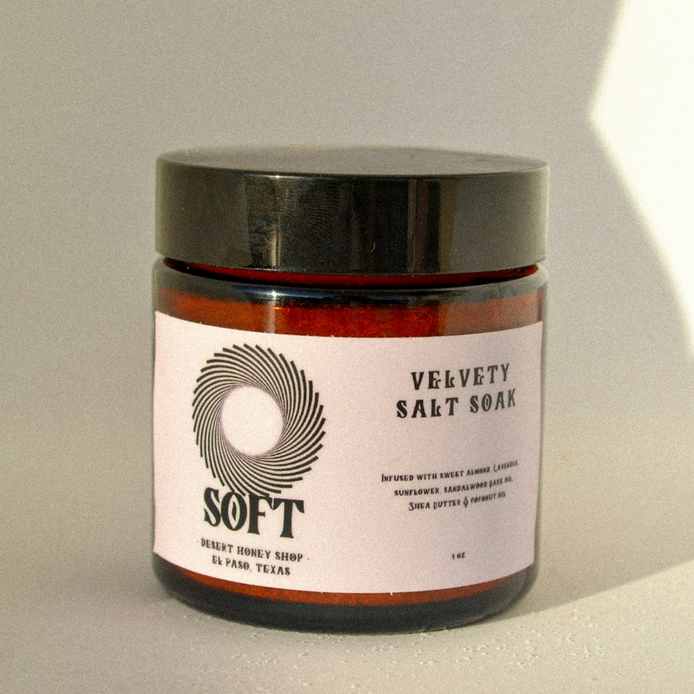 a jar of red stuff sitting on top of a white table