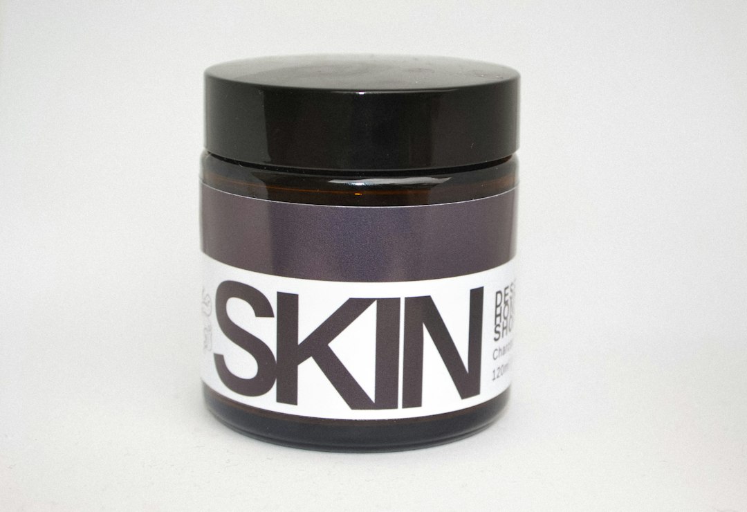 Jar of creamy propolis salve on a light surface for daily skin care