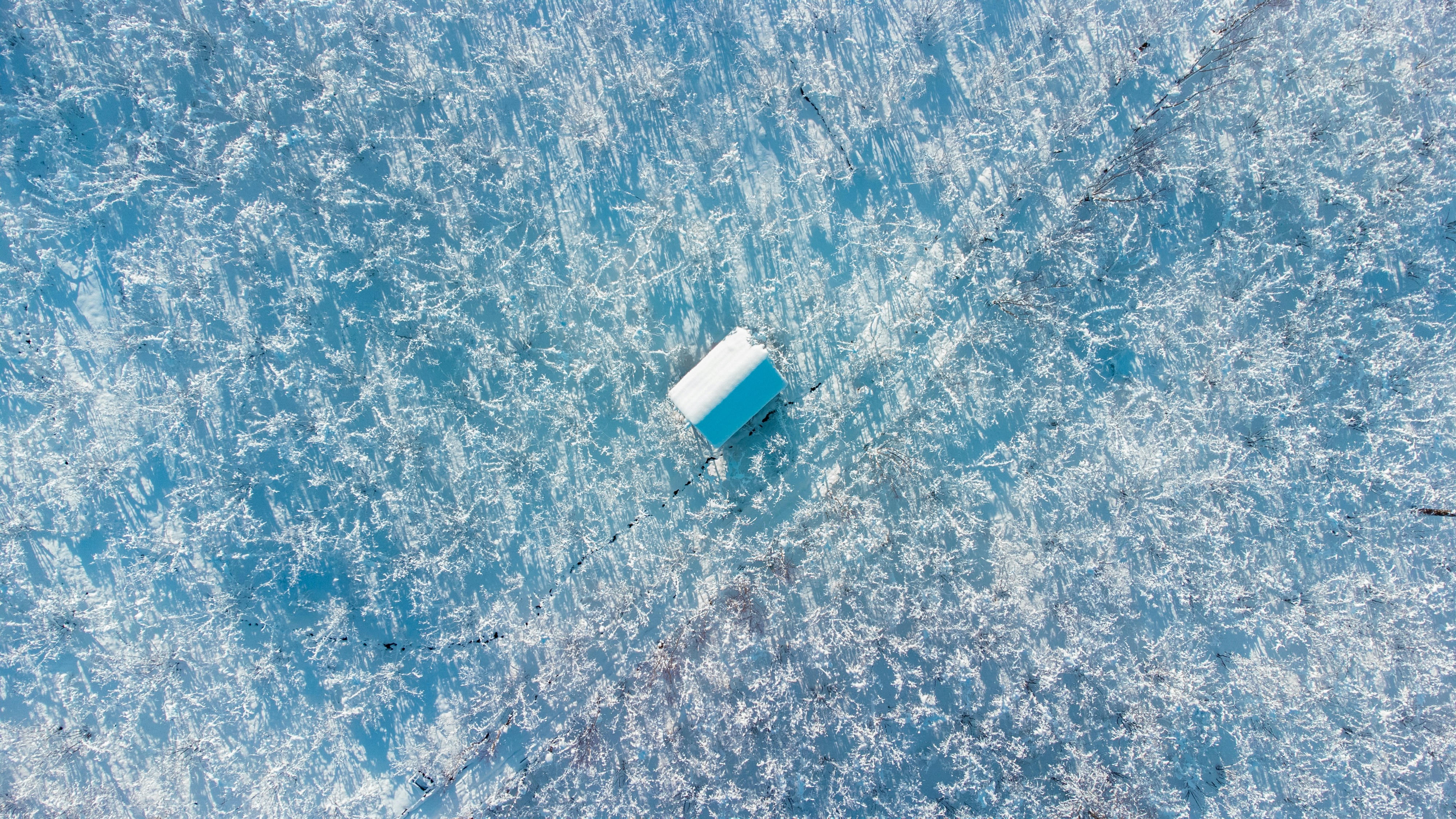 an aerial view of an ice covered lake
