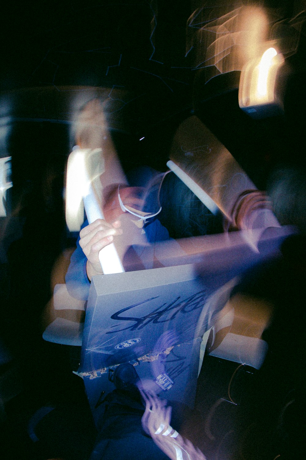 a blurry photo of a person holding a box