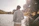 a man standing next to a body of water
