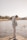 a man standing on a dock next to a body of water