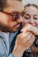 a man putting a ring on a woman's finger