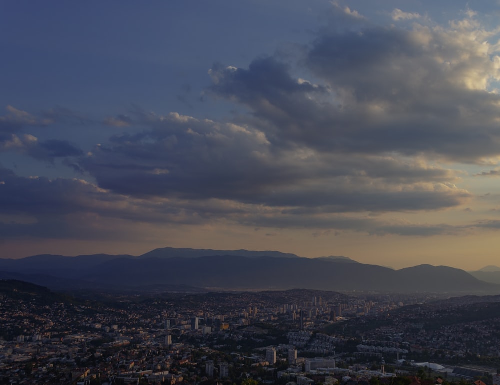 a view of a city with mountains in the background